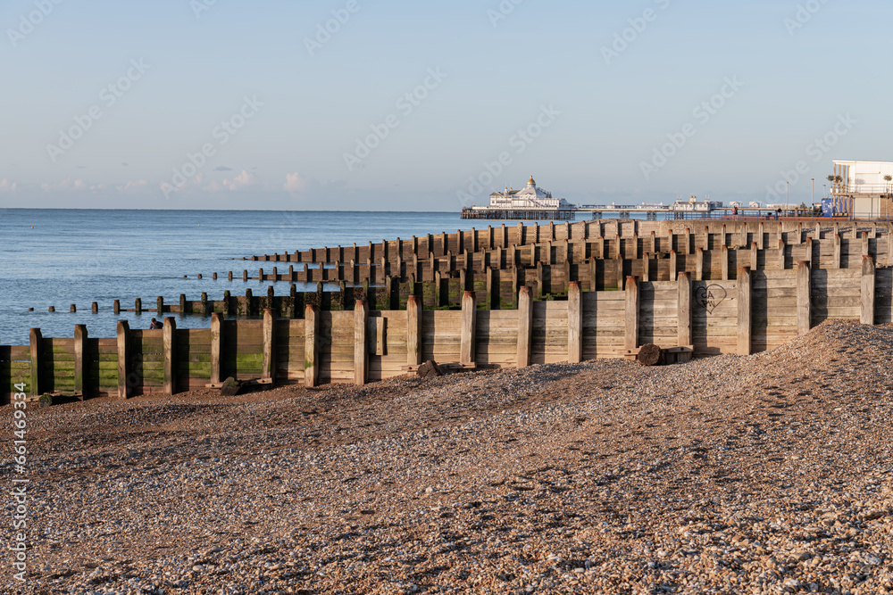 Eastbourne Pier and Beach with a clear blue sky and calm seas, Eastbourne, England