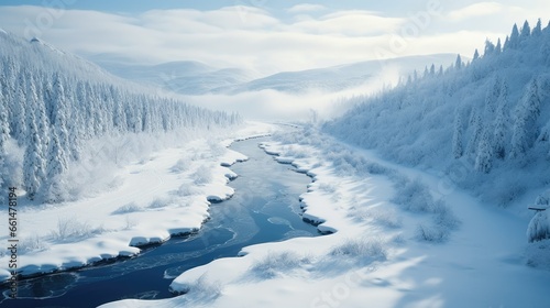 frozen river winding through a snow-covered valley © Daunhijauxx
