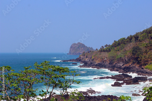Beautiful seascape with waves against rocks. High angle view of a beach in Trenggalek, East Java, Indonesia. photo