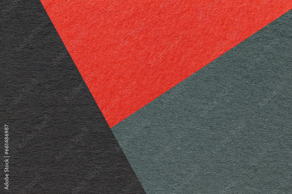 Fototapeta premium Texture of craft black, red and teal shade color paper background, macro. Vintage abstract cardboard