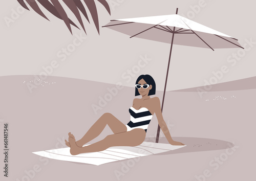 A young stylish woman relaxes on the sandy shore beneath a white beach umbrella, enjoying her summer getaway amidst the sweltering tropical heat