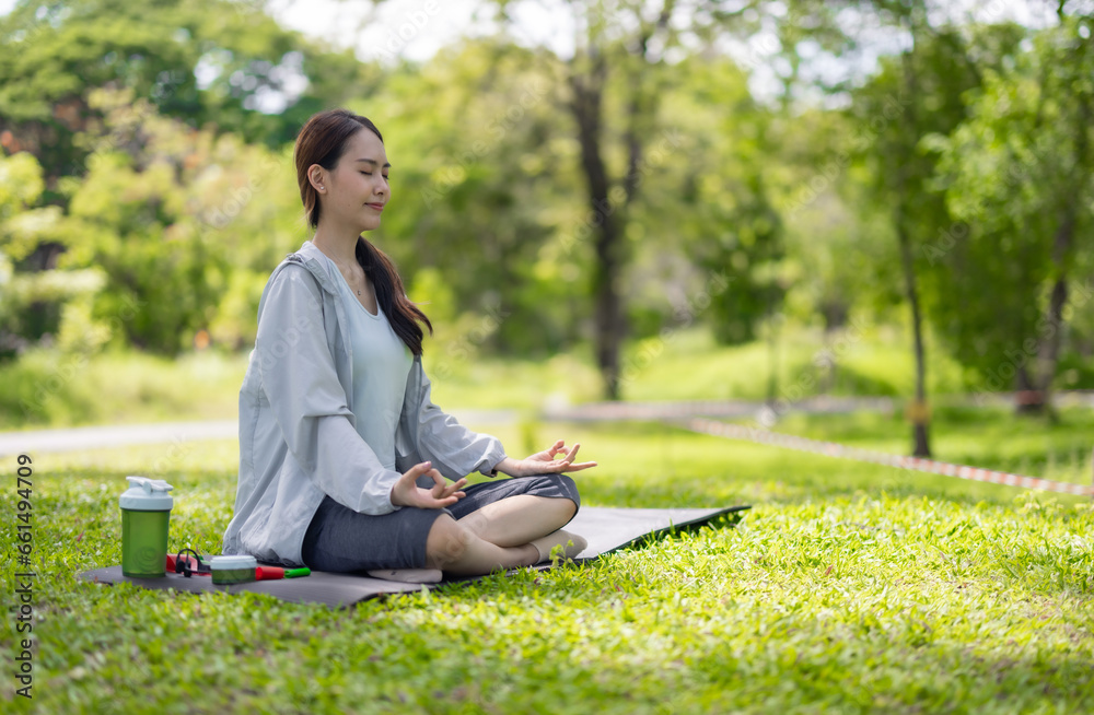 Young Asian woman revitalized through park yoga, meditation, aligning body, mind, restoring energy. Young Asian woman revitalized through park yoga, meditation, aligning body, mind, restoring energy.