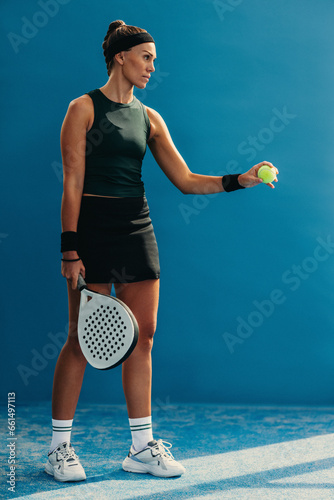 Woman preparing for a serve in padel tournament match