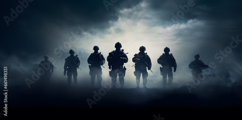 Army soldiers with his guns on a dark background photo