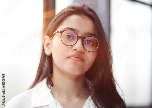 A close up head shot portrait of a preppy, young, beautiful, confident and attractive woman