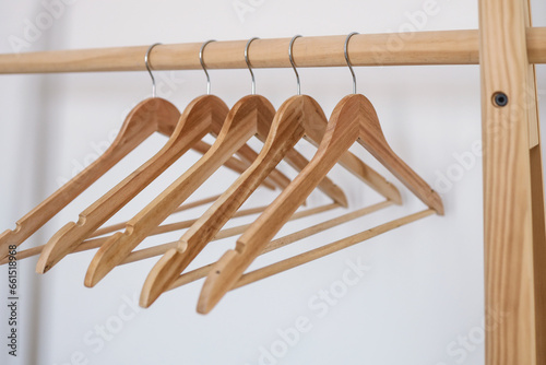 Wooden coat hanger / clothes hanger on a white background. Potential copy space above and inside hanger photo