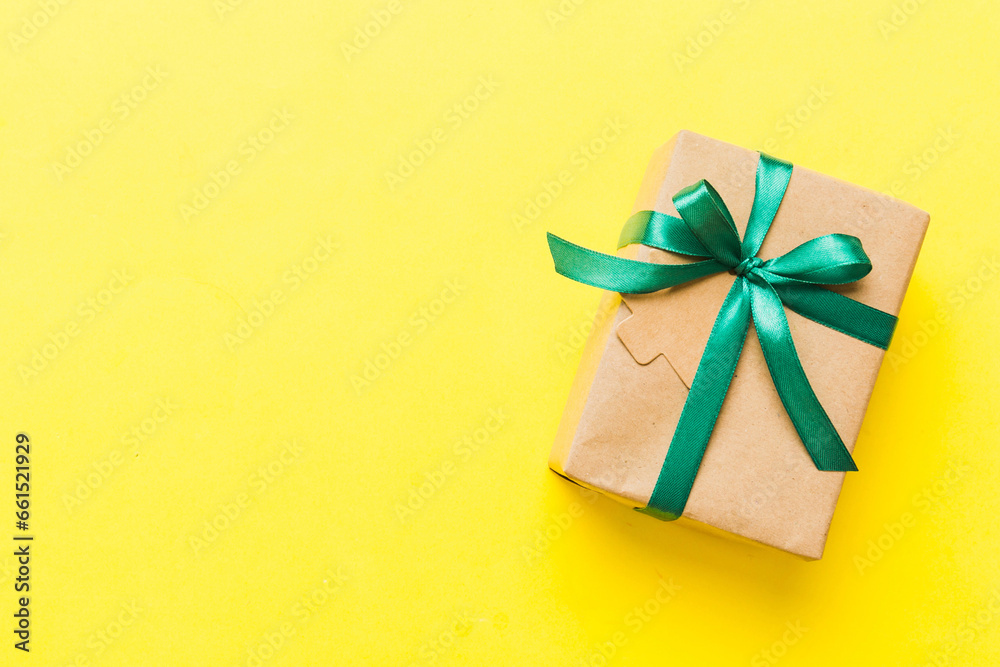 wrapped christmas or other holiday handmade present in paper with colored ribbon. Present box, decoration of gift on colourfull table, top view with copy space wrapped christmas or other holiday handmade present in paper with colored ribbon. Present box, decoration of gift on colourfull table, top view with copy space