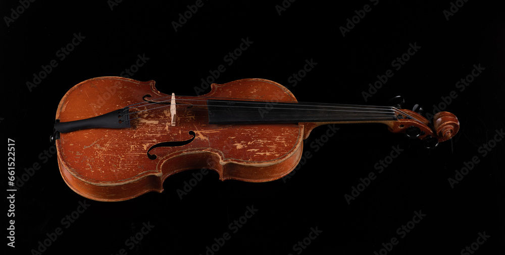 Fototapeta premium old violin isolated on black background