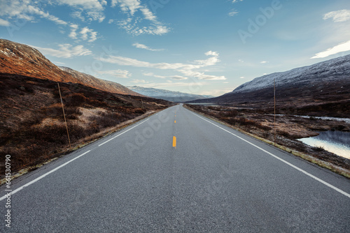 View of a road on high altitude leading through the norweigian mountains in autumn. photo