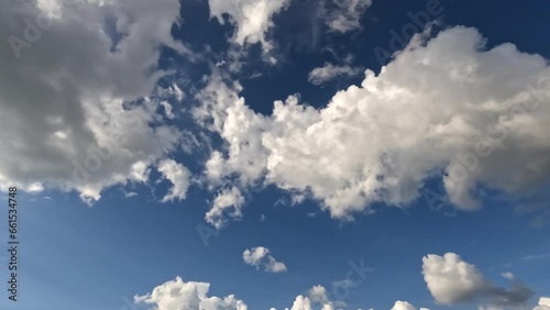Time-lapse of beautiful blue sky with cloudy movement. Puffy fluffy white clouds. Cumulus cloudscape time lapse. photo