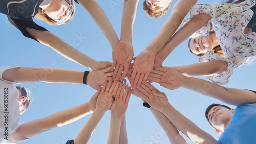 Seven boys and girls join hands as a sign of strong friendship.