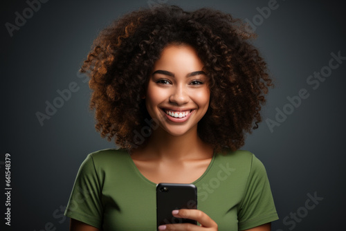 African american smiling happy woman in green t-shirt on dark blue background