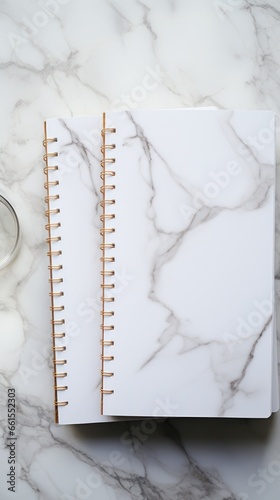white and square notebook on a marble background