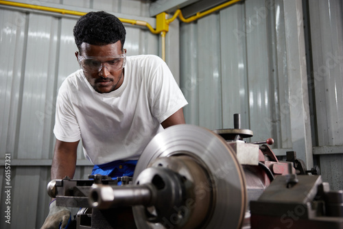 factory worker or technician working and control lathe machine in factory © offsuperphoto