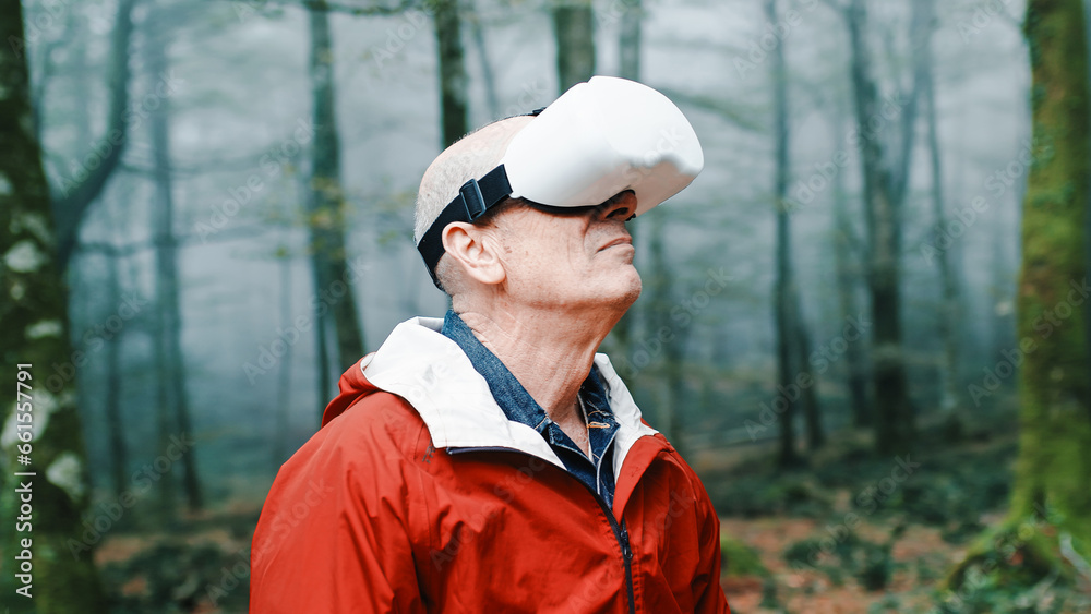 Elderly man is experienced the virtual reality in the nature into the forest Elderly man is experienced the virtual reality in the nature into the forest