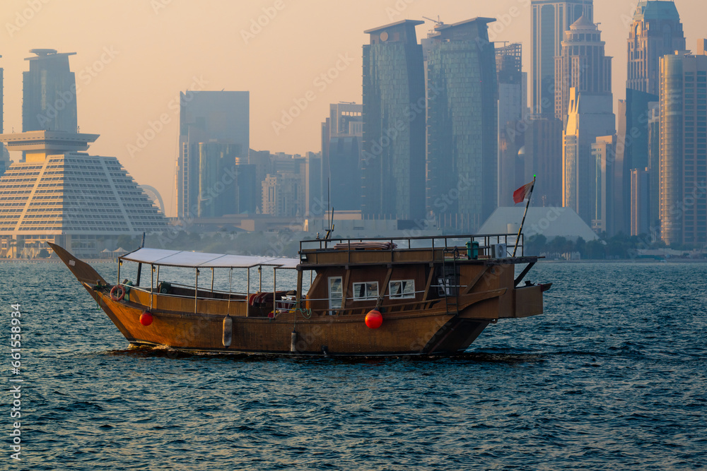 An old historic boat with an unobstructed panoramic view of Doha's modern skyline.