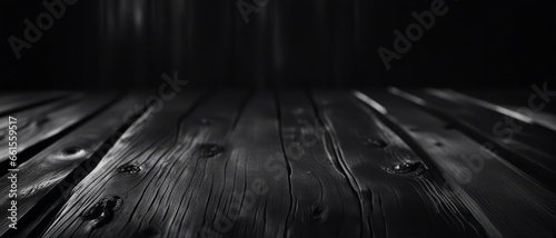 Black abstract grunge background. Burnt wooden surface with marks and nicks from an ax. photo