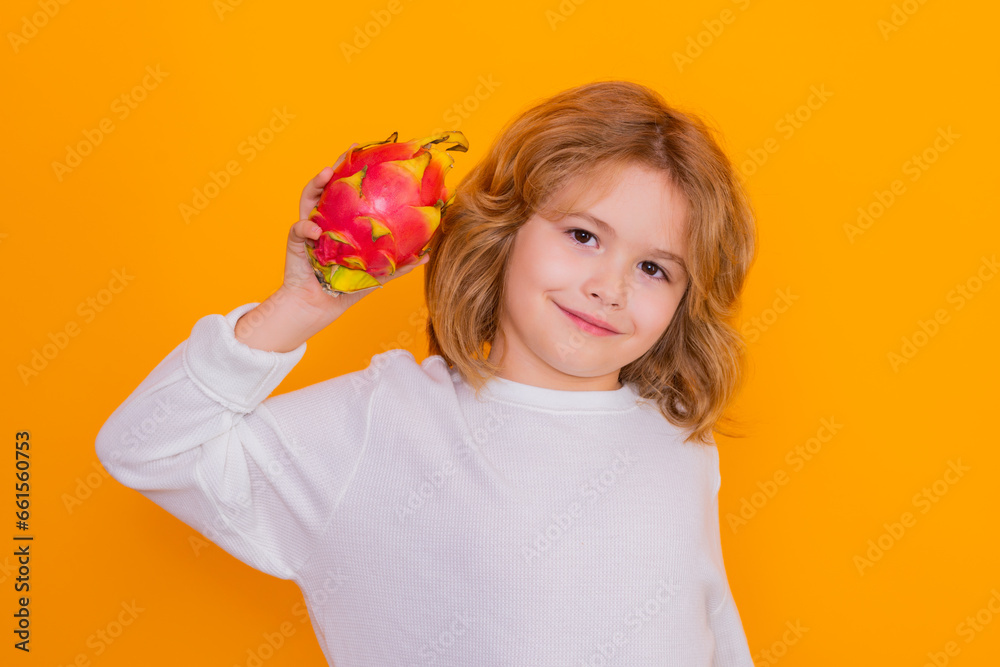 Dragon fruit. Kid hold dragon fruit in studio. Studio portrait of cute child with dragon fruit isolated on yellow background, copy space. Dragon fruit. Kid hold dragon fruit in studio. Studio portrait of cute child with dragon fruit isolated on yellow background, copy space.