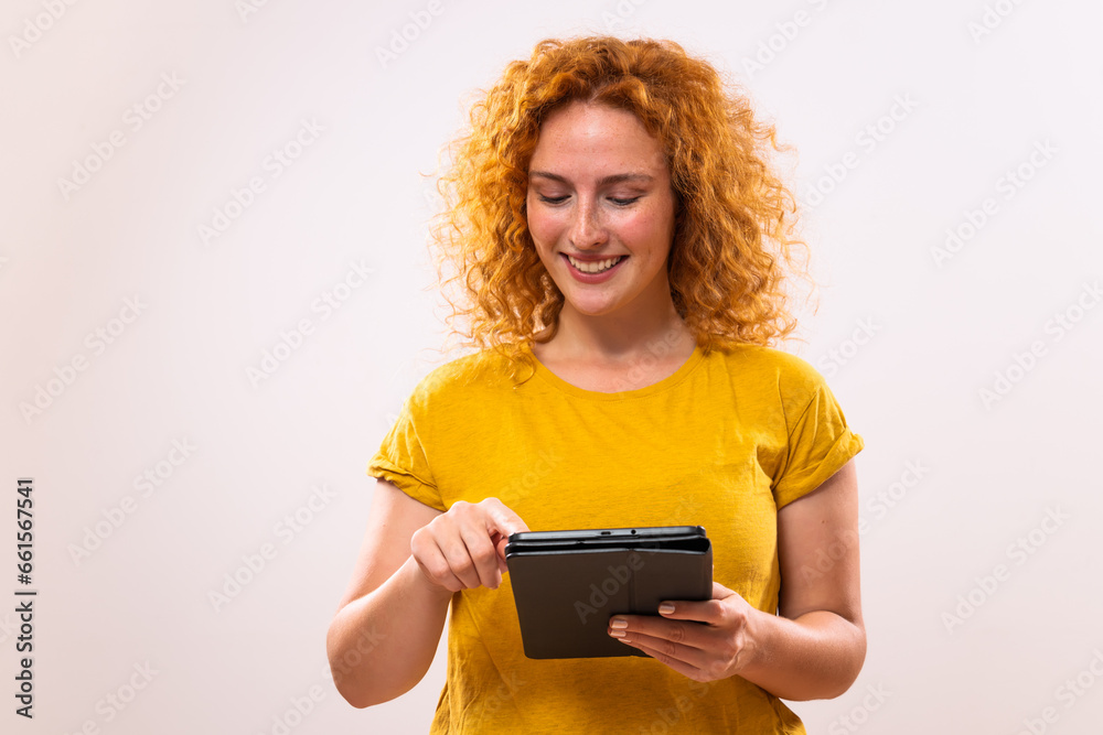 Image of happy ginger woman using digital tablet. Image of happy ginger woman using digital tablet.