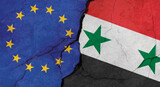 EU and Syria flags, concrete wall texture with cracks, grunge background, military conflict concept