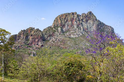 Exploring the Serrania de Chochis with the gigantic reddish rock formation Torre de David near the picturesque village Chochis near Santa Cruz de la Sierra in Bolivia - Traveling South America photo