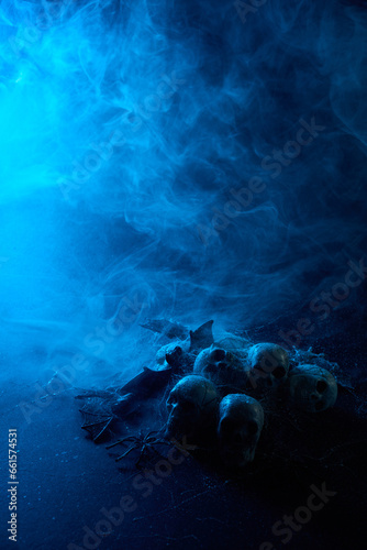 Halloween human skulls in abstract smoke on black background.
