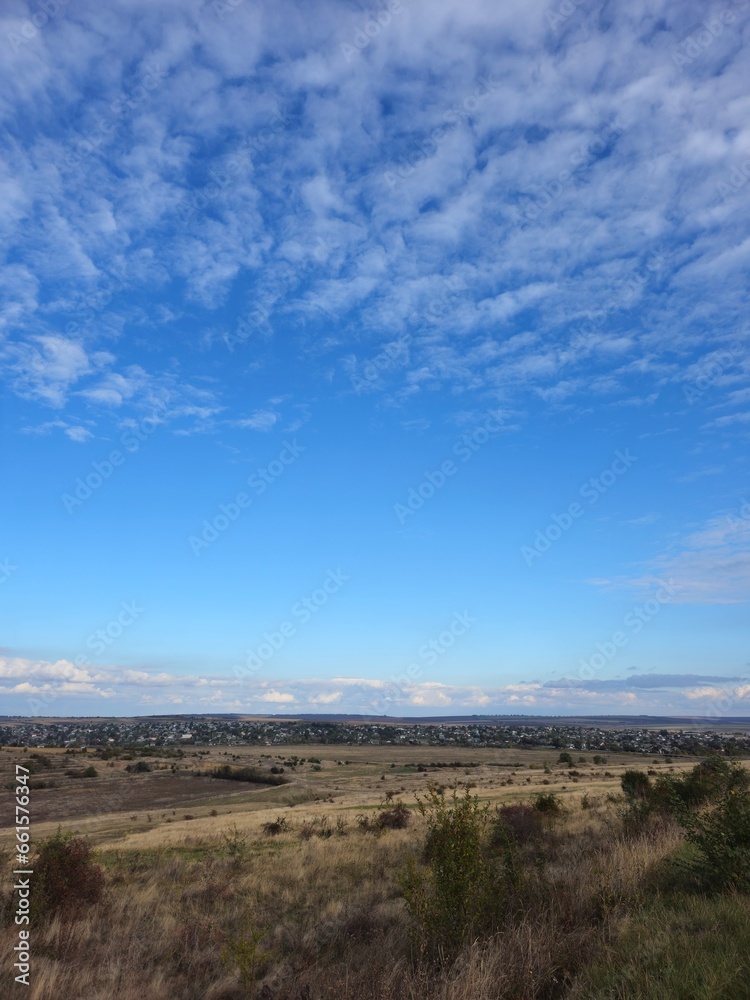 A landscape with a blue sky and clouds A landscape with a blue sky and clouds