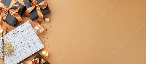 Prepare for the holiday season's arrival. Top view flat lay of calendar, festive presents, xmas balls, shiny snowflake, stars confetti on terracotta background with promo slot photo