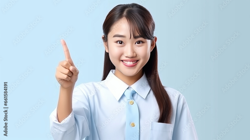 smiling of teen student girl of Asian ethnicity in university uniform pointing finger away. smiling of teen student girl of Asian ethnicity in university uniform pointing finger away.