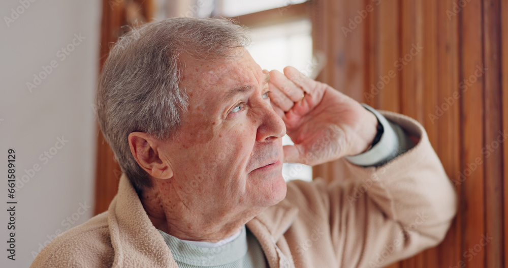 Depression, sad or nostalgia with a senior man looking through a window in his home during retirement. Thinking, memory or the past with an elderly person feeling lonely in the living room of a house Depression, sad or nostalgia with a senior man looking through a window in his home during retirement. Thinking, memory or the past with an elderly person feeling lonely in the living room of a house