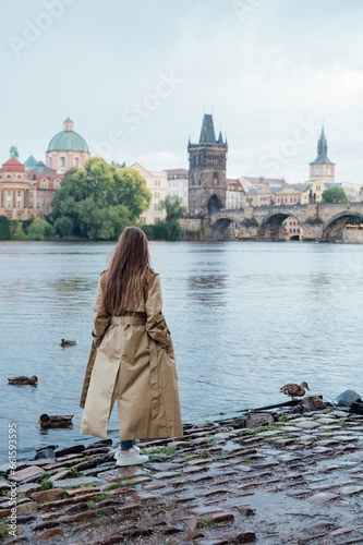 Young female tourist enjoying great view on the old town of Prague.