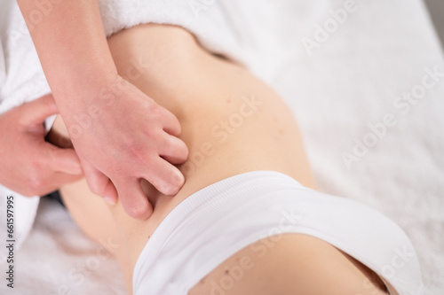 Crop woman awaiting baby getting massage from masseuse