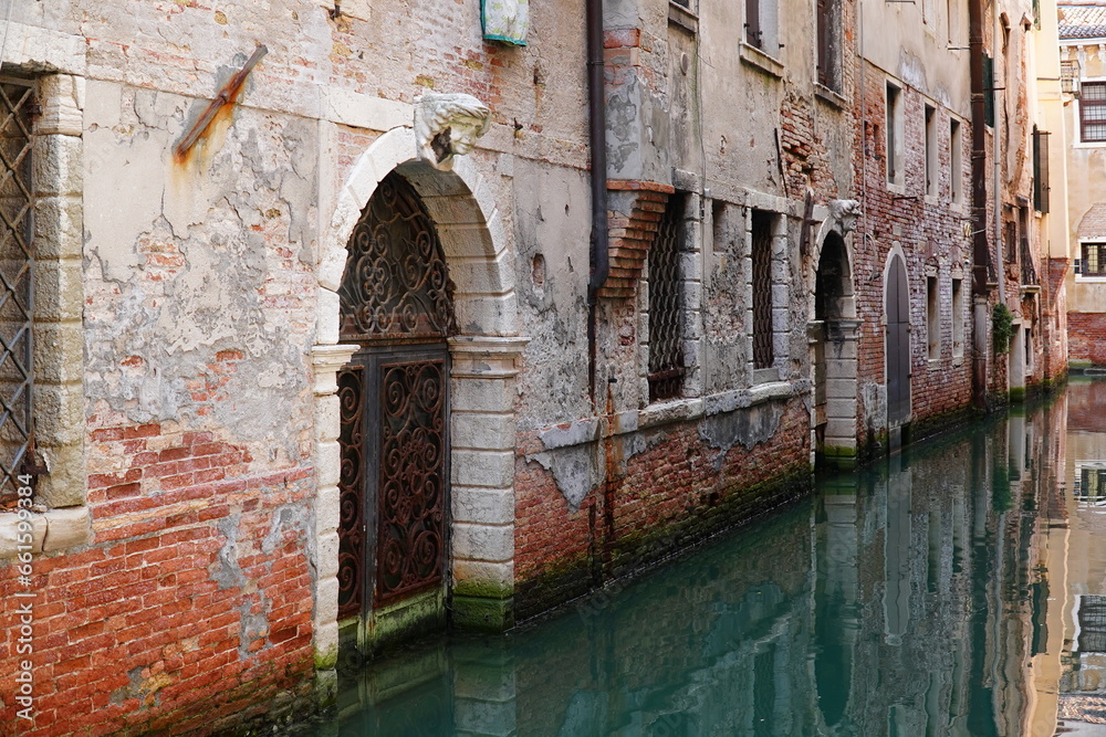 Salt damage to old bricks and marble in Venice, due to repeated flooding with salt water from the Adriatic coast of the Mediterranean Sea. Full image with erosion damage. Venice, Italy, Europe.