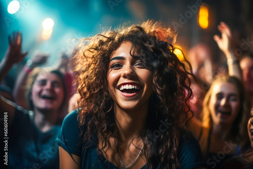 Young woman experiencing joy in a crowd at a festival.