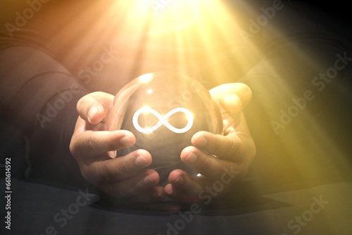 Infinity Mind Power Glass ball fortune teller, abundance , Lucky manifestation concepts. Hand holding virtual reality Infinity symbol. unlimited and infinity power business Lucky fortune telling.