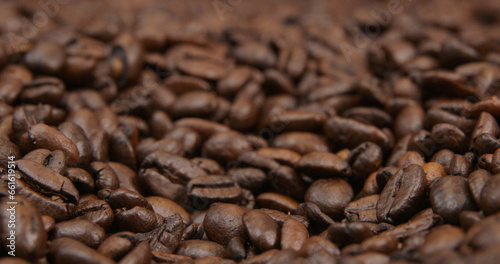 Coffee beans spread out on table close up