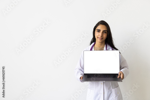 Positive female doctor with laptop on white background