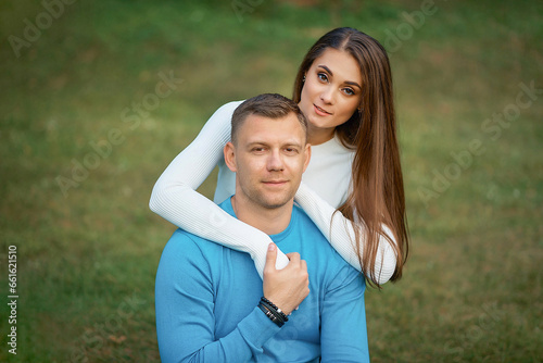 Beautiful young loving couple hugging and smiling while spending time on a walk