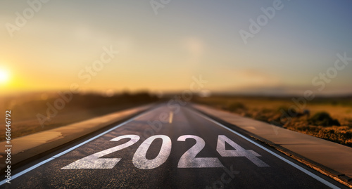 empty street with the new year 2024 written on the road - concept of setting goals for the next year photo