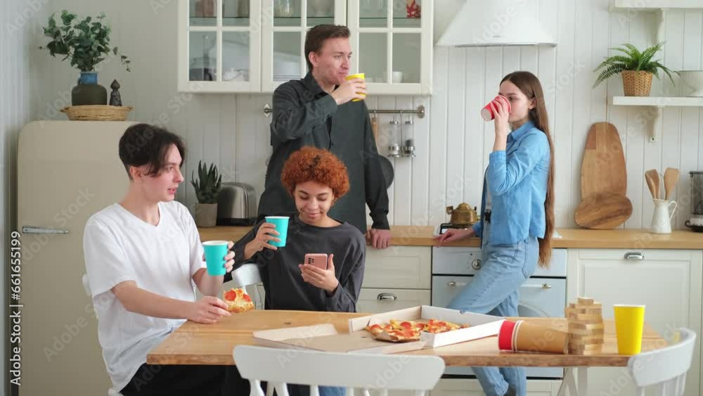 Home party. Friends spending time together having fun laughing communicating at home. Happy diverse group eating pizza drinking beer or lemonade. Mixed race young buddies best friends enjoying weekend Home party. Friends spending time together having fun laughing communicating at home. Happy diverse group eating pizza drinking beer or lemonade. Mixed race young buddies best friends enjoying weekend