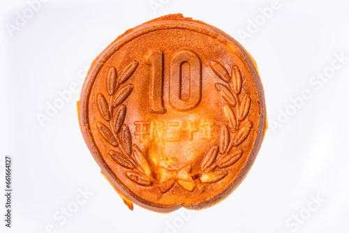Close up on a pancake shaped like a Japanese 10 yen coin which is a chewy dough full of cheese modelled on the edible 10 won coins known as Golden 10-Won Bread that have become popular in South Korea.