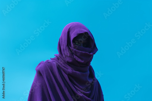 African man in purple with a turquoise sky in the background.