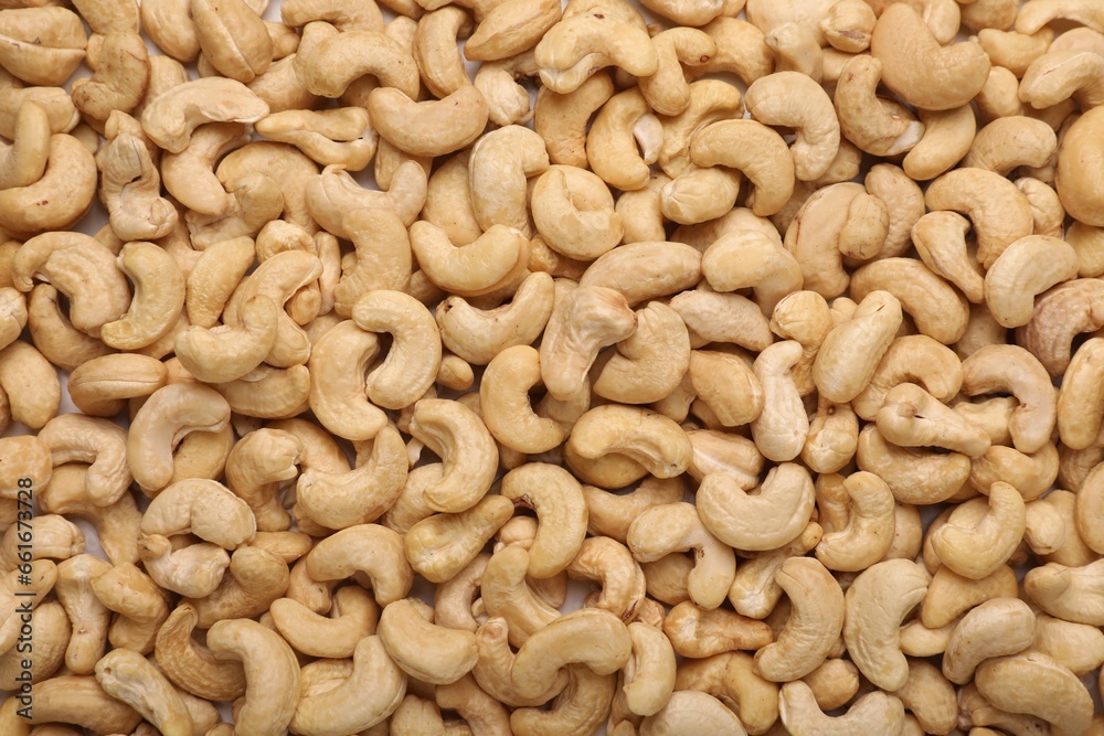 Many tasty cashew nuts as background, top view