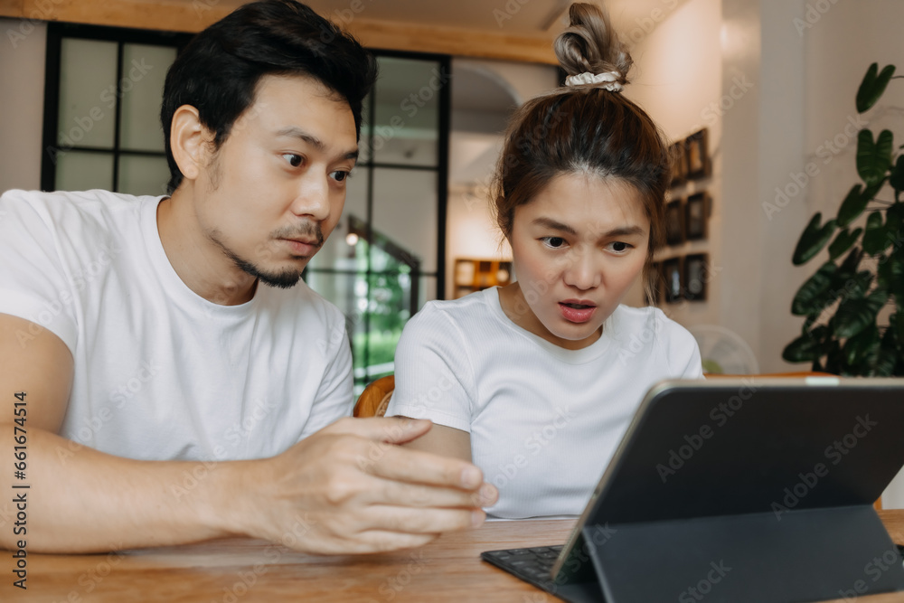 Man teaching and showing woman with computer tablet in the cafe, Asian couple. Man teaching and showing woman with computer tablet in the cafe, Asian couple.