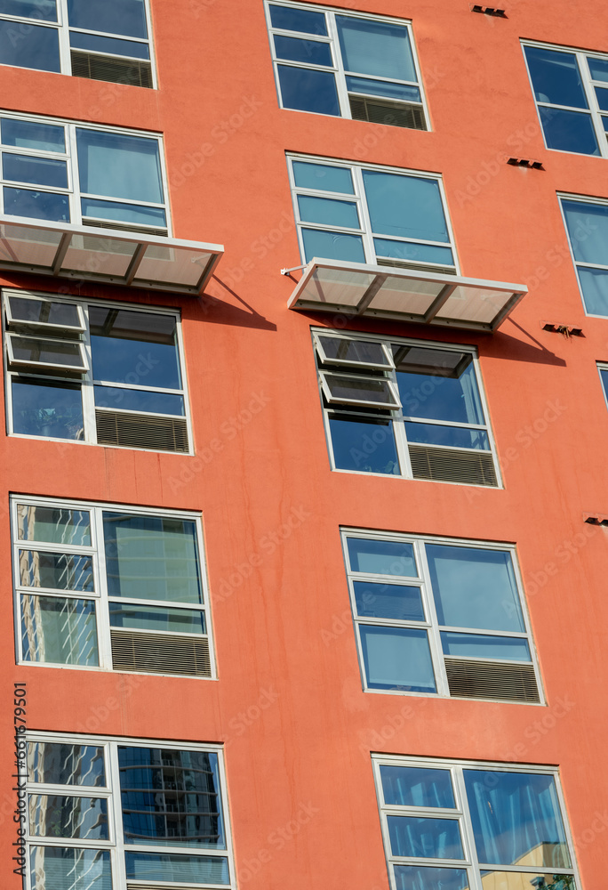 Obraz premium Red Building Wall with Silver Window Frames.