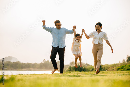 Photography Happy family running through a beautiful green field on a sunny summer day, enjo