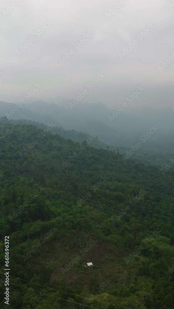 Mountains and green hills in Sumatra. Slopes of mountains with evergreen vegetation. Indonesia. Mountains and green hills in Sumatra. Slopes of mountains with evergreen vegetation. Indonesia.