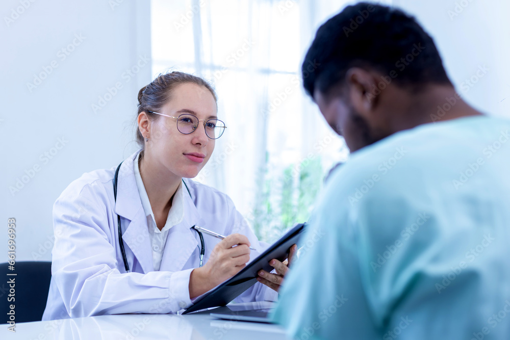 Doctor holding checklist and talking to man Patient at hospital. Physician examining male patient in hospital room.. Doctor holding checklist and talking to man Patient at hospital. Physician examining male patient in hospital room..