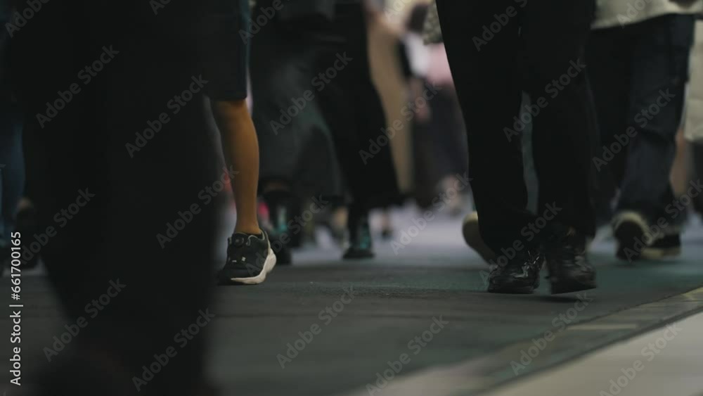 Crowd of people walking. Legs of a crowd of people walking down the street. Many feet walk on the pavement. Society and city life concept. City lifestyle concept Crowd of people walking. Legs of a crowd of people walking down the street. Many feet walk on the pavement. Society and city life concept. City lifestyle concept