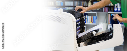 Technician hand open cover photocopier or photocopy to fix repair copier problem paper jam and replace ink cartridges for scanning fax or copy document in office workplace concept of service support. photo